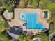 Aerial view of the pool and surrounding lounge area, shaded by mature trees, perfect for relaxation at 1420 Willowleaf Way, Apex, NC 27502