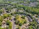 Aerial view of a neighborhood featuring tree-lined streets, green spaces, and various home styles, creating a vibrant community at 1420 Willowleaf Way, Apex, NC 27502