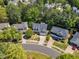 Aerial view showcasing a home's location within a neighborhood with mature trees, landscaping and street appeal at 1420 Willowleaf Way, Apex, NC 27502