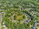 A neighborhood is laid out with tree-lined streets, green common areas, and diverse housing, offering a close-knit feel at 1420 Willowleaf Way, Apex, NC 27502