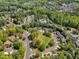 Neighborhood aerial view reveals a well-planned community surrounded by lush greenery and mature trees, emphasizing serene living at 1420 Willowleaf Way, Apex, NC 27502