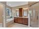 Elegant bathroom with dual sinks, a soaking tub, and a glass-enclosed shower at 1420 Willowleaf Way, Apex, NC 27502