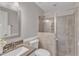 Well-lit bathroom featuring a granite countertop, updated shower, and neutral wall color at 1420 Willowleaf Way, Apex, NC 27502