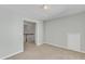 Neutral bedroom featuring a beige carpet and adjacent hallway view at 1420 Willowleaf Way, Apex, NC 27502