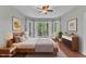 Beautiful bedroom featuring a large bed, bay window with nature views, and modern furnishings at 1420 Willowleaf Way, Apex, NC 27502
