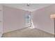 Comfortable bedroom with fresh paint, plush carpet, and a window with neighborhood views at 1420 Willowleaf Way, Apex, NC 27502