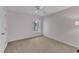 Cozy bedroom with soft pink walls, ceiling fan, plush carpet and large window at 1420 Willowleaf Way, Apex, NC 27502