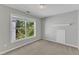 Neutral bedroom featuring a large window with natural light and plush carpet at 1420 Willowleaf Way, Apex, NC 27502