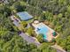 Aerial view of the community pool, tennis courts, and surrounding green space at 1420 Willowleaf Way, Apex, NC 27502