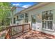 A charming house shows off its light colored, spacious deck perfect for outdoor living with views of the surrounding landscape at 1420 Willowleaf Way, Apex, NC 27502