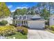 Charming two-story home with a welcoming front porch, well-maintained lawn, and attached garage at 1420 Willowleaf Way, Apex, NC 27502