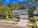 Aerial view of a charming home with well-maintained landscaping, a white picket fence, and a welcoming front porch at 1420 Willowleaf Way, Apex, NC 27502