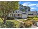 Charming two-story home with a welcoming front porch, well-maintained lawn, and attached garage at 1420 Willowleaf Way, Apex, NC 27502