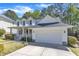 Charming two-story home with a welcoming front porch, well-maintained lawn, and attached garage at 1420 Willowleaf Way, Apex, NC 27502