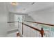 Bright hallway with white railings overlooking a cozy living room at 1420 Willowleaf Way, Apex, NC 27502
