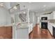 Bright kitchen features white cabinetry, a breakfast bar, and hardwood floors at 1420 Willowleaf Way, Apex, NC 27502