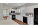 Spacious kitchen with white cabinets, hardwood floors, and modern appliances at 1420 Willowleaf Way, Apex, NC 27502