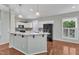 Bright kitchen features granite counters, and modern black appliances at 1420 Willowleaf Way, Apex, NC 27502