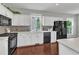 Kitchen with modern appliances, ample countertop space, and hardwood floors at 1420 Willowleaf Way, Apex, NC 27502