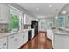 Charming kitchen features white cabinetry, modern appliances, and lots of natural light at 1420 Willowleaf Way, Apex, NC 27502