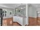 Open-concept kitchen with breakfast bar and hardwood floors at 1420 Willowleaf Way, Apex, NC 27502