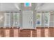 Bright and airy living room featuring large windows and hardwood floors at 1420 Willowleaf Way, Apex, NC 27502