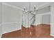 Spacious living area with hardwood floors, chandelier, and natural light at 1420 Willowleaf Way, Apex, NC 27502
