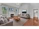 Open-concept living room with vaulted ceilings, fireplace, and large windows at 1420 Willowleaf Way, Apex, NC 27502