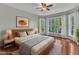 Inviting main bedroom features hardwood floors, large windows and ceiling fan at 1420 Willowleaf Way, Apex, NC 27502