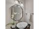 Stylish powder room featuring a decorative mirror, unique sink, and elegant decor at 1420 Willowleaf Way, Apex, NC 27502