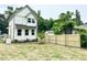 The backyard features a wooden fence and a young tree, offering a private outdoor space at 1448A Maplewood Dr, Durham, NC 27704