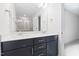 Bright bathroom featuring double sinks, a large mirror, and glass enclosed shower at 1448A Maplewood Dr, Durham, NC 27704
