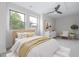 The staged bedroom offers two windows, ceiling fan, and neutral colors at 1448A Maplewood Dr, Durham, NC 27704