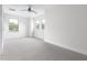 This bedroom features new carpet, three windows, and a ceiling fan at 1448A Maplewood Dr, Durham, NC 27704
