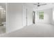 This spacious carpeted bedroom features a window, doorway to a bathroom, and ceiling fan at 1448A Maplewood Dr, Durham, NC 27704