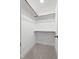 Bright closet space featuring carpet flooring, white walls, and multiple rods for maximum storage at 1448A Maplewood Dr, Durham, NC 27704