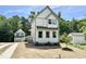 Charming two-story home features a white exterior, gray trim, and a cozy front porch at 1448A Maplewood Dr, Durham, NC 27704