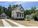 Charming two-story home features a white exterior, gray trim, and a cozy front porch at 1448A Maplewood Dr, Durham, NC 27704