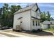 Two-story home with white siding, gray trim, covered entry, and a well-lit facade at 1448A Maplewood Dr, Durham, NC 27704