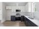 Well-lit kitchen features stainless steel appliances, white cabinets, subway tile backsplash, and light wood-look floors at 1448A Maplewood Dr, Durham, NC 27704