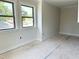 Bright living room featuring large windows and neutral paint at 1448A Maplewood Dr, Durham, NC 27704