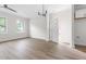 Bright living room with sleek hardwood floors, modern lighting, and ample natural light at 1448A Maplewood Dr, Durham, NC 27704