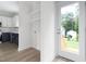 The mudroom features shelving, a door to the backyard, and hookups for a washer and dryer at 1448A Maplewood Dr, Durham, NC 27704