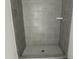 Walk-in shower featuring gray tile and a built-in shower caddy at 1448A Maplewood Dr, Durham, NC 27704
