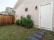Exterior shot of the backyard with stepping stones to an exterior door on the property at 1517 Millrock Trl, Wendell, NC 27591