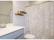 Bathroom featuring a shower with a leafy curtain, vanity, and wooden floating shelves at 1517 Millrock Trl, Wendell, NC 27591