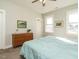 Comfortable bedroom with natural light, wood dresser, and neutral walls and carpet at 1517 Millrock Trl, Wendell, NC 27591