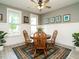 Charming dining room features a round wooden table, rug, and ample natural light at 1517 Millrock Trl, Wendell, NC 27591