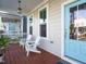 Relax on this charming front porch with two white Adirondack chairs and a bright blue door at 1517 Millrock Trl, Wendell, NC 27591