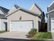 A two-door garage exterior shot with a driveway and some landscaping on the side at 1517 Millrock Trl, Wendell, NC 27591